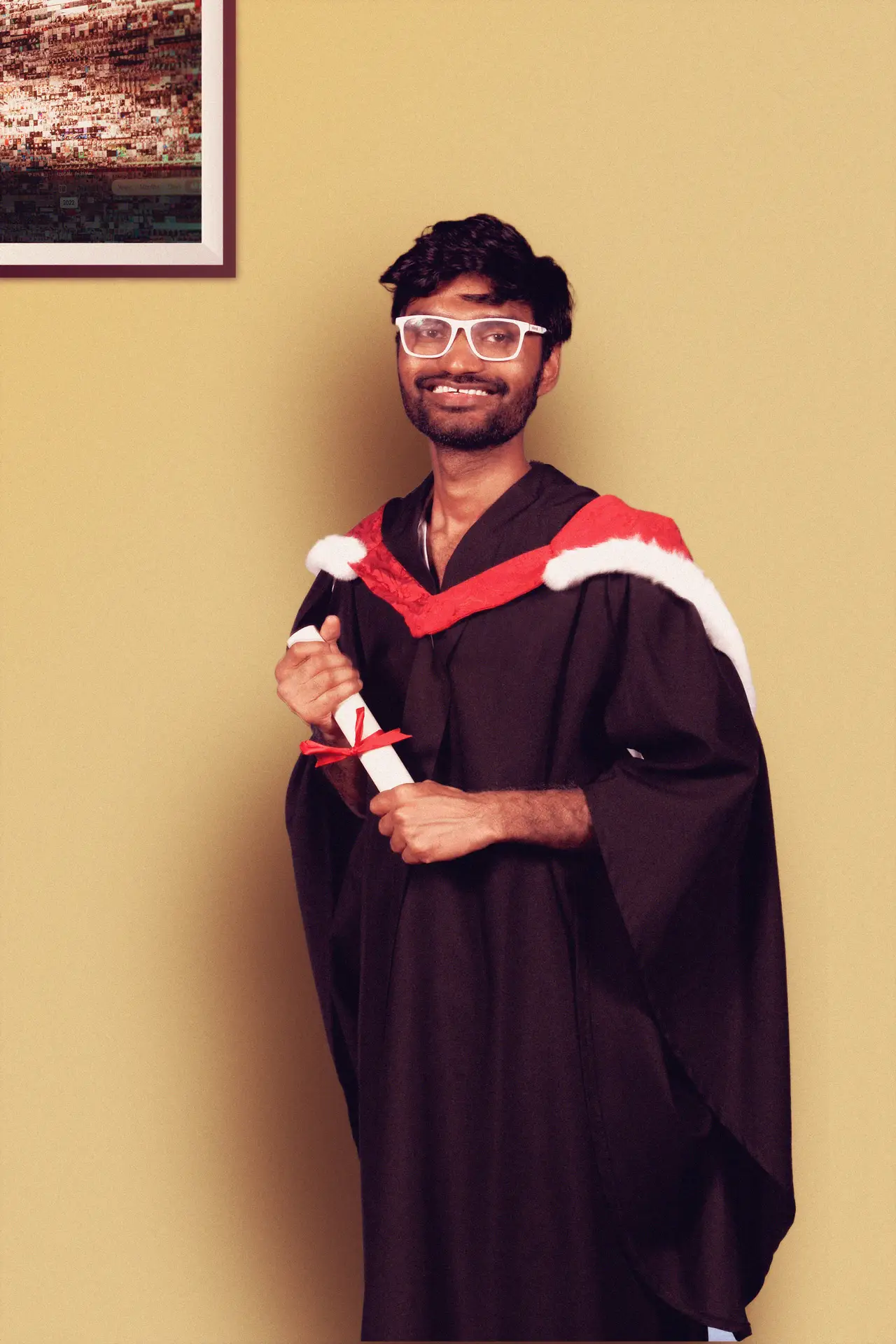 boy standing with degree